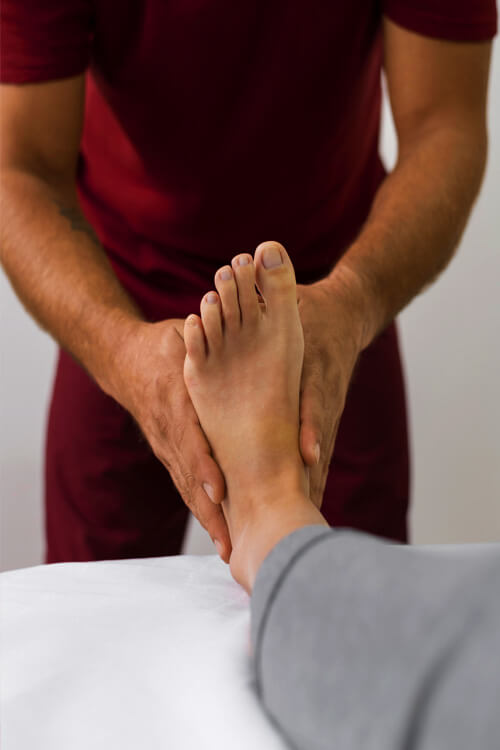 Physiotherapist assisting a patient during a therapy session at Omega Physiotherapy clinic
