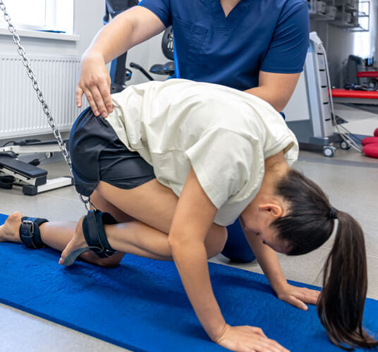 Physiotherapist assisting a patient during post-car accident rehabilitation session